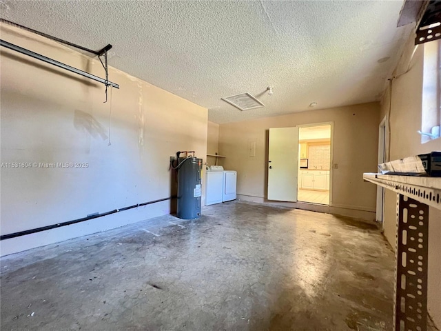 garage with independent washer and dryer and electric water heater