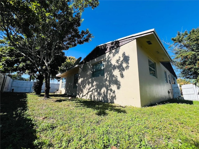 view of home's exterior featuring a yard