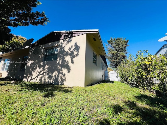 view of home's exterior featuring a lawn