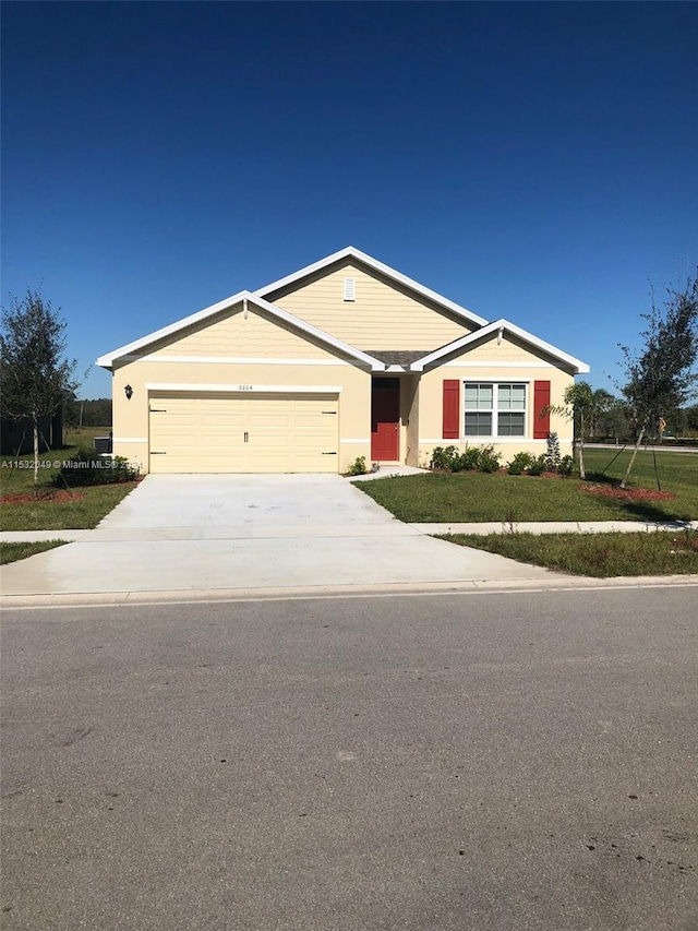 single story home featuring a front yard and a garage