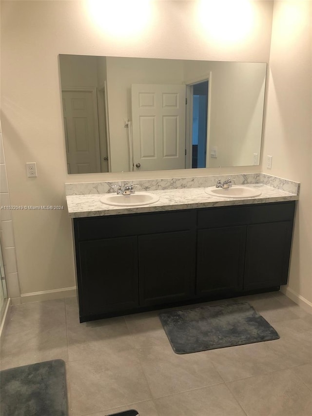 bathroom with double vanity and tile floors