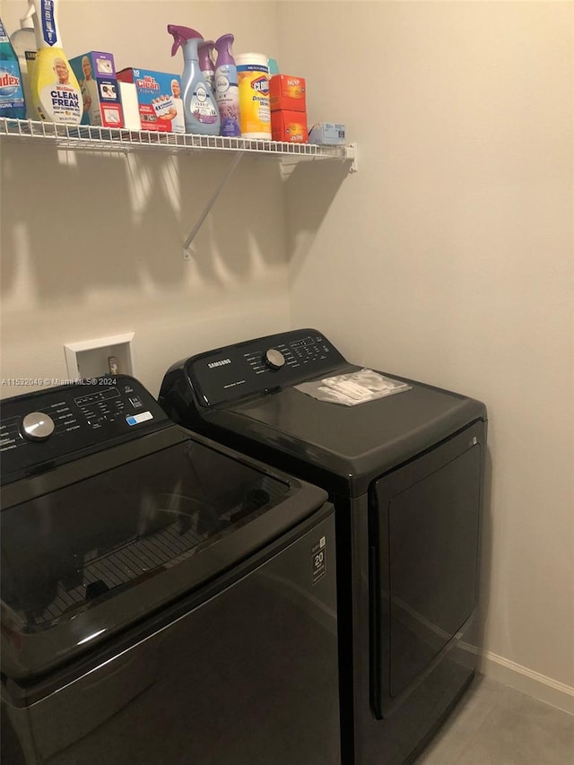 laundry area featuring washer hookup, independent washer and dryer, and light tile floors