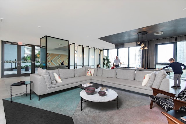 living room with a chandelier and french doors