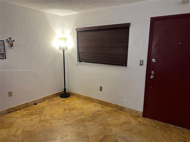 spare room featuring a textured ceiling