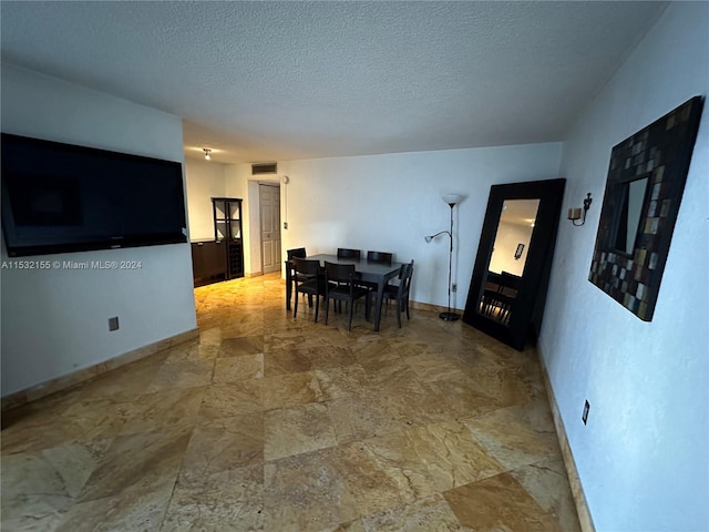 dining room with a textured ceiling