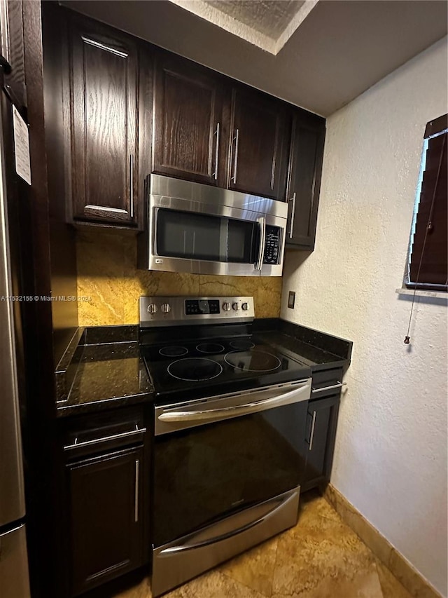 kitchen featuring light tile patterned floors, tasteful backsplash, appliances with stainless steel finishes, and dark brown cabinetry