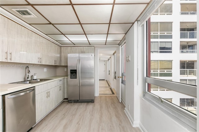 kitchen featuring appliances with stainless steel finishes, light wood-type flooring, and sink