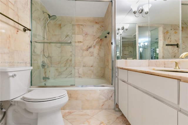 full bathroom featuring combined bath / shower with glass door, vanity, and toilet