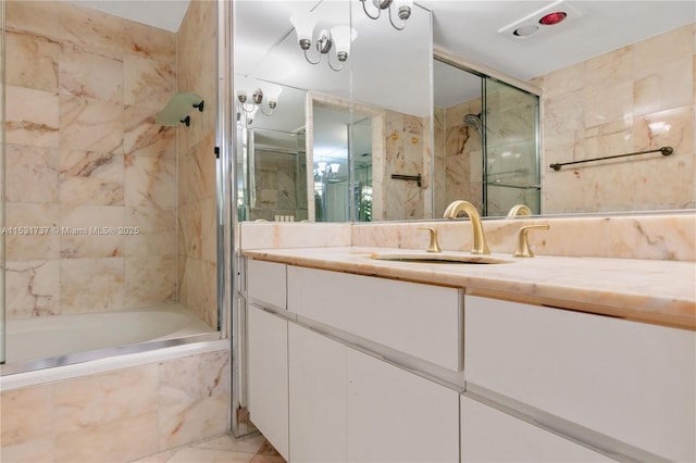 bathroom featuring vanity and enclosed tub / shower combo