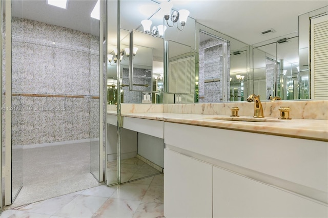 bathroom featuring vanity and a notable chandelier