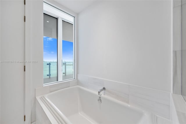 bathroom with a relaxing tiled bath