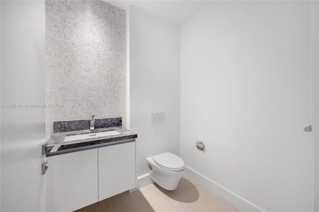 bathroom featuring toilet, tile flooring, and vanity