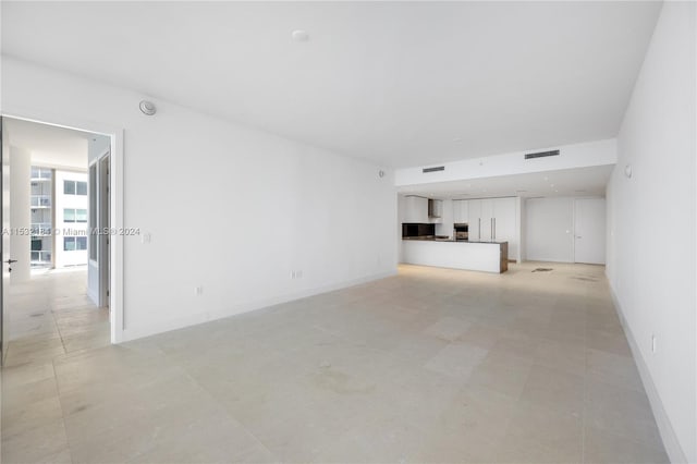 unfurnished living room with light tile floors