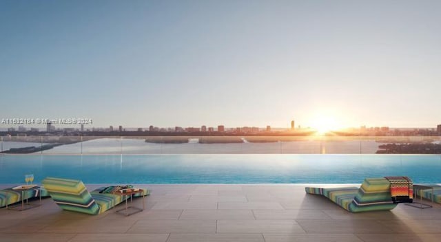 view of pool at dusk