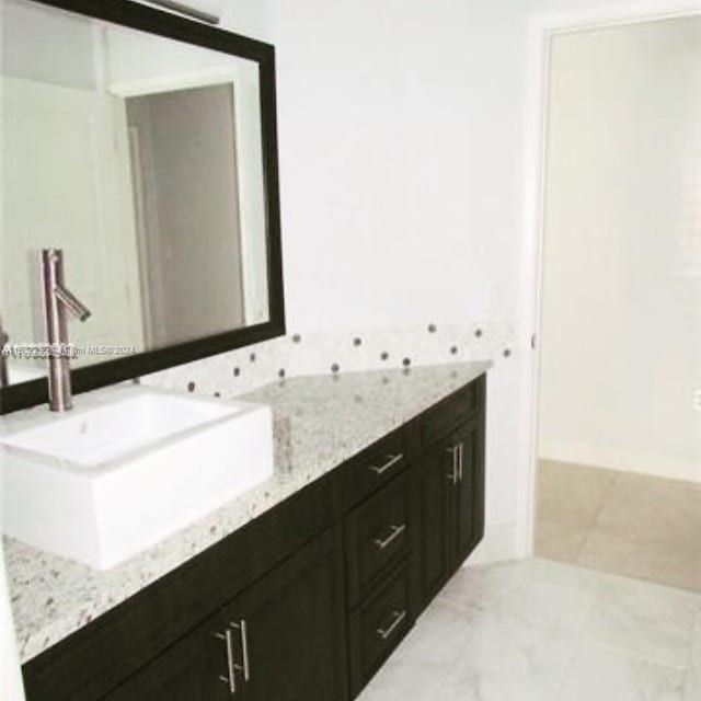 bathroom featuring large vanity, tile floors, and double sink