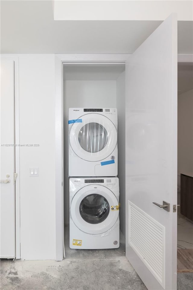 laundry area with stacked washer / dryer