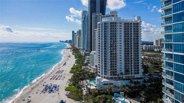 birds eye view of property with a view of the beach and a water view