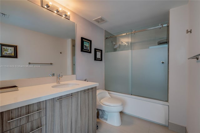 full bathroom with vanity, tile flooring, shower / bath combination with glass door, and toilet