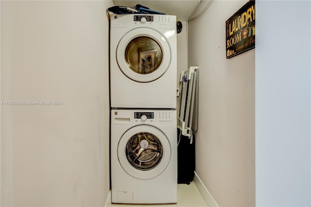 clothes washing area featuring stacked washing maching and dryer