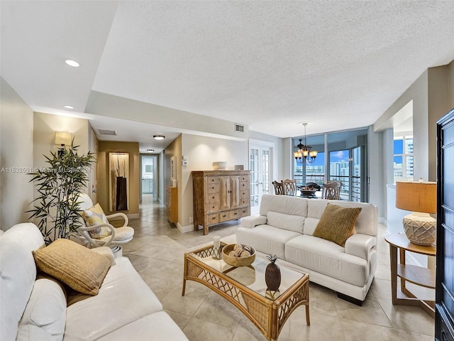 tiled living room with an inviting chandelier and a textured ceiling