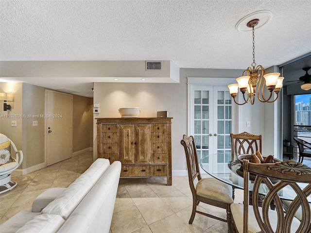 tiled dining room featuring a textured ceiling, a notable chandelier, and french doors