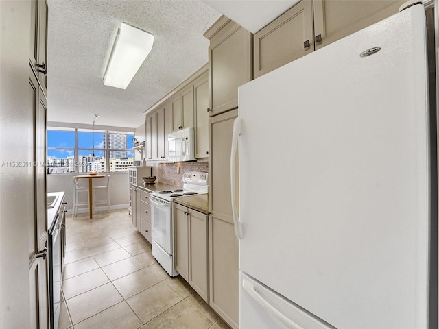 kitchen featuring light tile floors, decorative light fixtures, a textured ceiling, tasteful backsplash, and white appliances