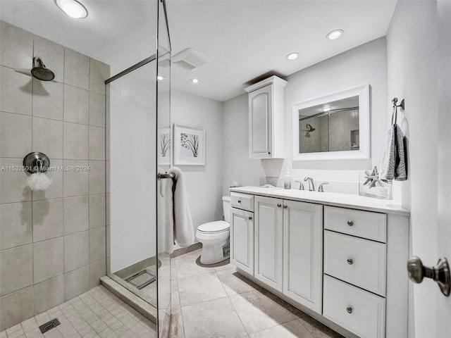 bathroom featuring walk in shower, tile flooring, oversized vanity, and toilet