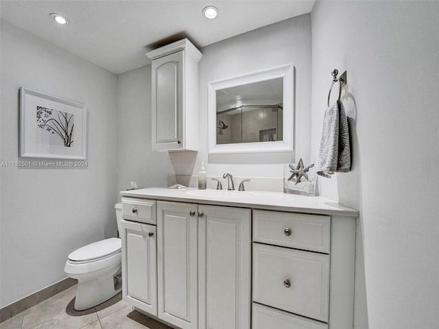 bathroom with toilet, tile floors, and vanity