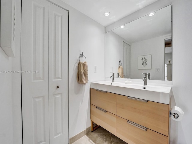 bathroom featuring dual bowl vanity and tile floors