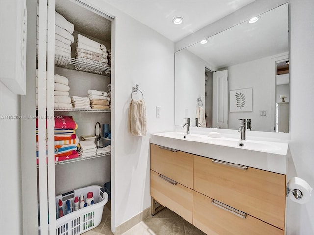 bathroom with vanity and tile flooring