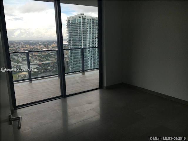 unfurnished room with a wall of windows