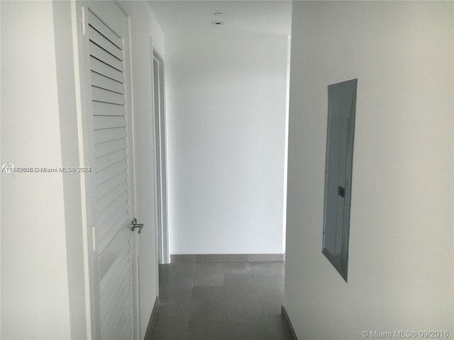 hallway with dark tile floors