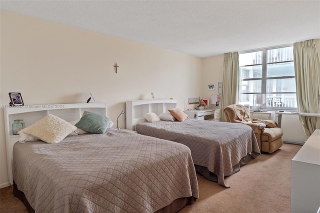 carpeted bedroom featuring a textured ceiling