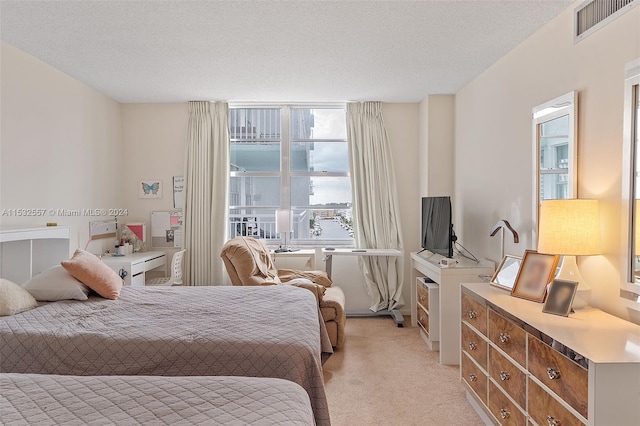 carpeted bedroom with a textured ceiling