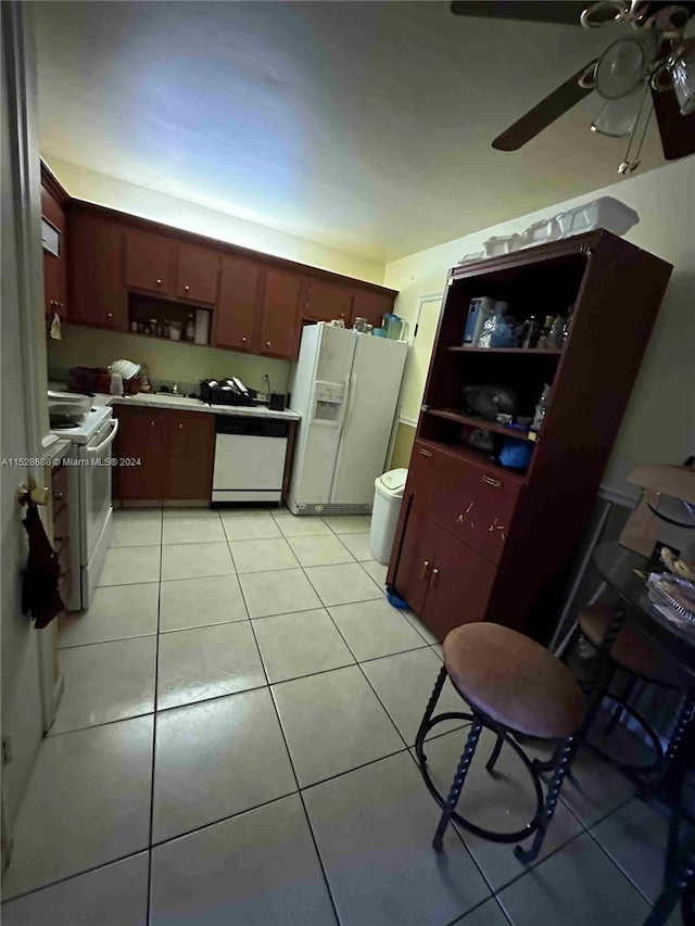 kitchen featuring white appliances, light tile patterned flooring, and ceiling fan