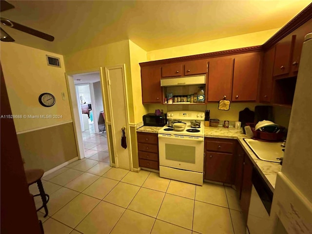 kitchen featuring ceiling fan, light tile patterned flooring, and white appliances