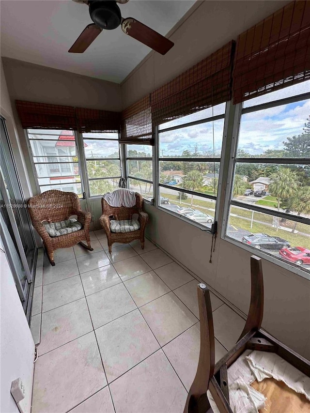 unfurnished sunroom featuring ceiling fan