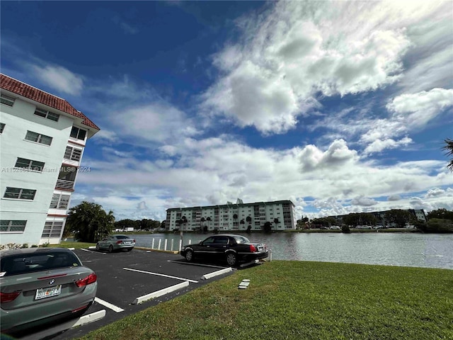 exterior space featuring a lawn and a water view