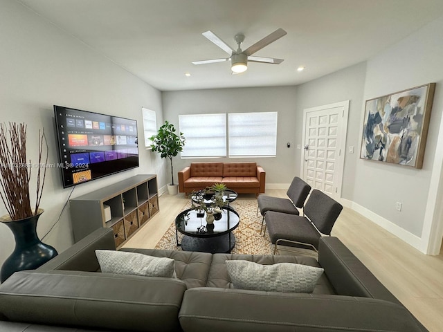 living room with light hardwood / wood-style floors and ceiling fan