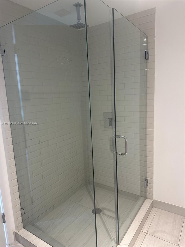 bathroom featuring tile flooring and walk in shower