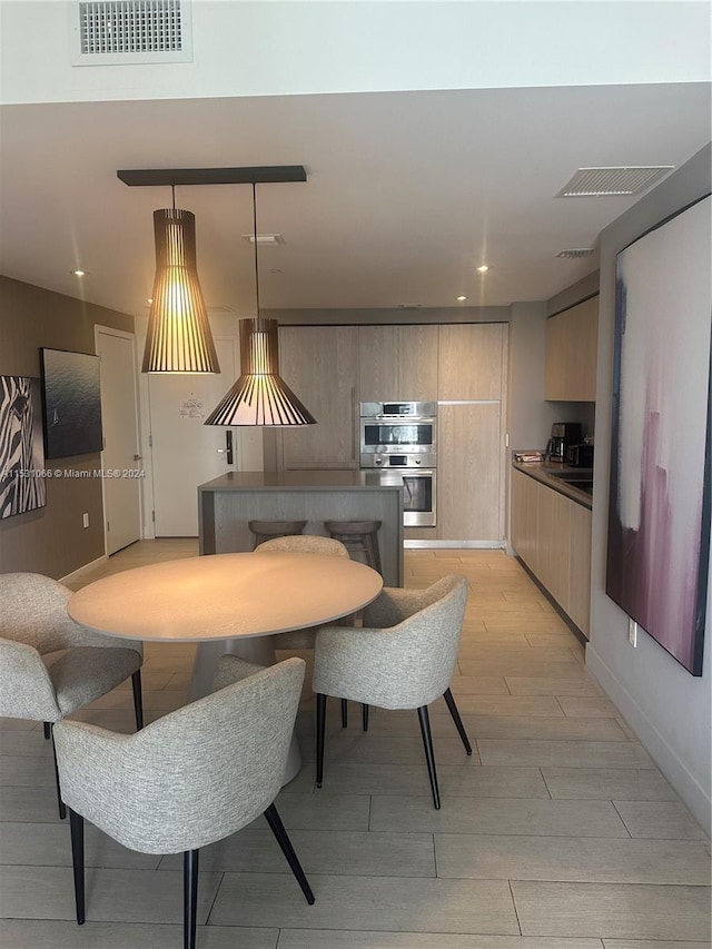 dining space with light hardwood / wood-style flooring