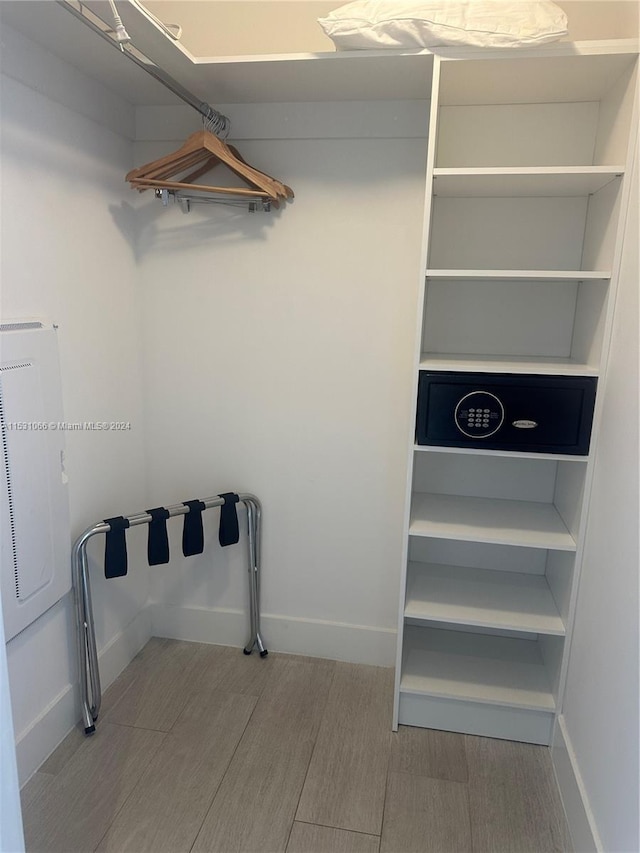 spacious closet featuring light hardwood / wood-style flooring