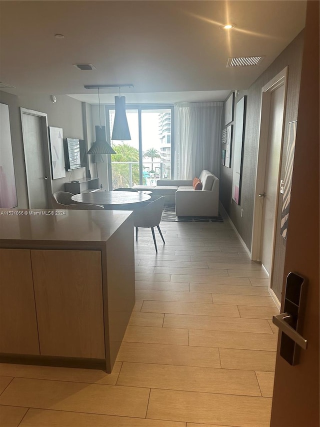 kitchen with pendant lighting and light hardwood / wood-style flooring