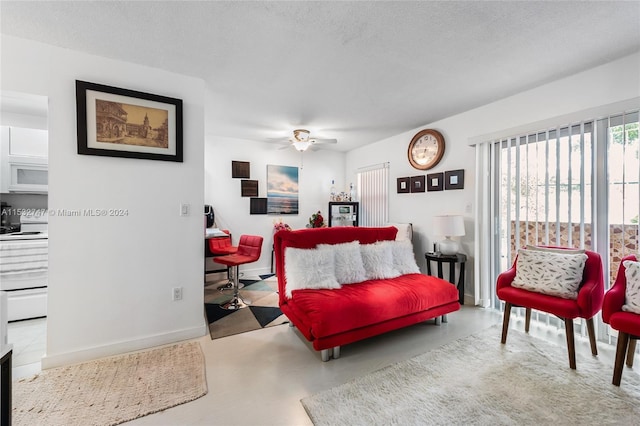 bedroom with ceiling fan and a textured ceiling