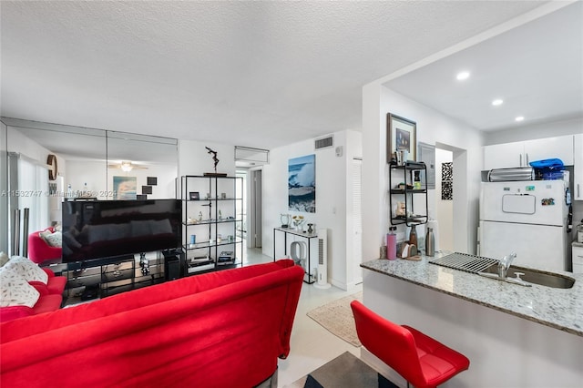 living room with sink and a textured ceiling