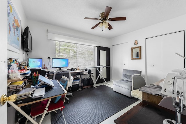 office space with ceiling fan and a textured ceiling