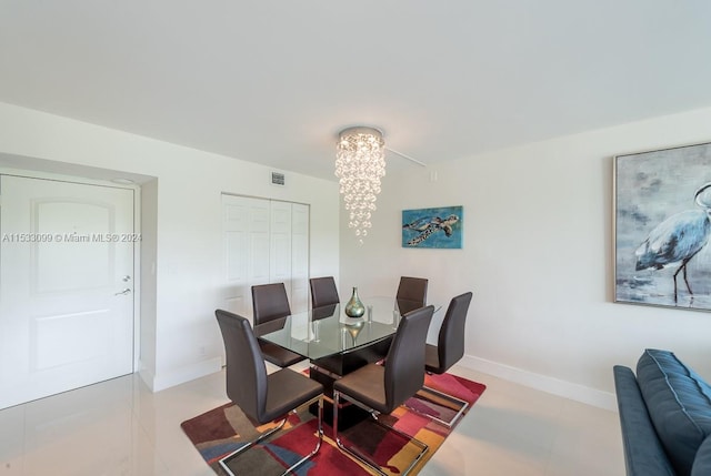 tiled dining space with a chandelier