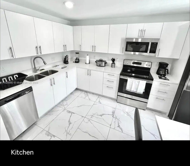 kitchen with stainless steel appliances and white cabinets