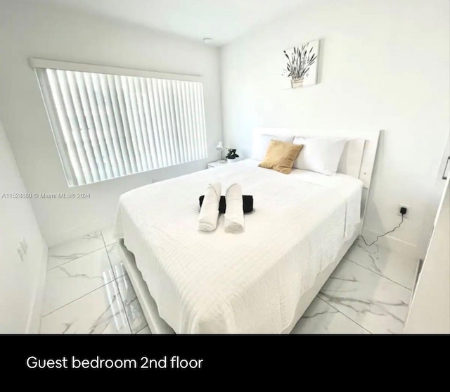 bedroom featuring light tile floors