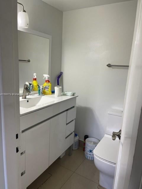 bathroom featuring vanity, tile flooring, and toilet